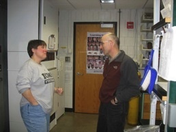 Two people talking in lab