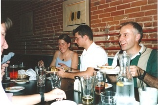 lab members talking at restaurant table