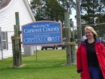 Standing in front of Welcome sign